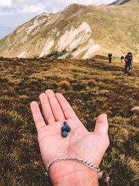 Low section of people hands on mountain
