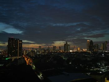 Illuminated cityscape against sky at night