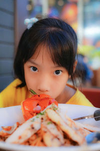Portrait of cute girl eating food