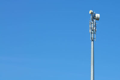 Low angle view of communications tower against sky