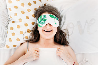 Portrait of smiling woman with face at home