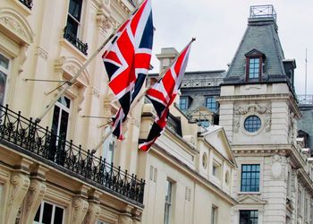 Low angle view of flag against buildings in city