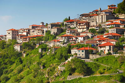 Buildings in city against clear sky