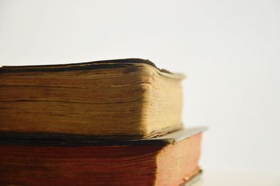 Close-up of stack of books against white background