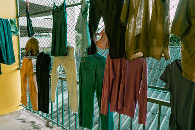 Rear view of clothes hanging at market stall