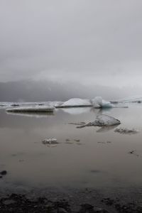 Scenic view of frozen sea against sky during winter