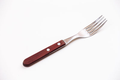 High angle view of fork over white background