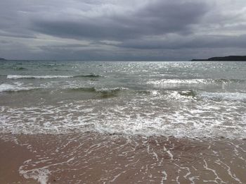 View of calm sea against cloudy sky