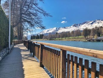 Scenic view of lake by mountains against sky