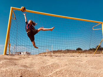 Full length of boy jumping at beach