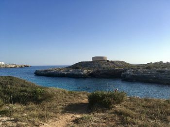 Scenic view of sea against clear blue sky