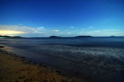 Scenic view of beach against sky at night