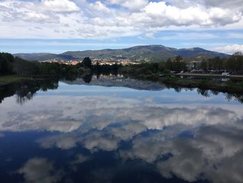 Scenic view of lake against cloudy sky