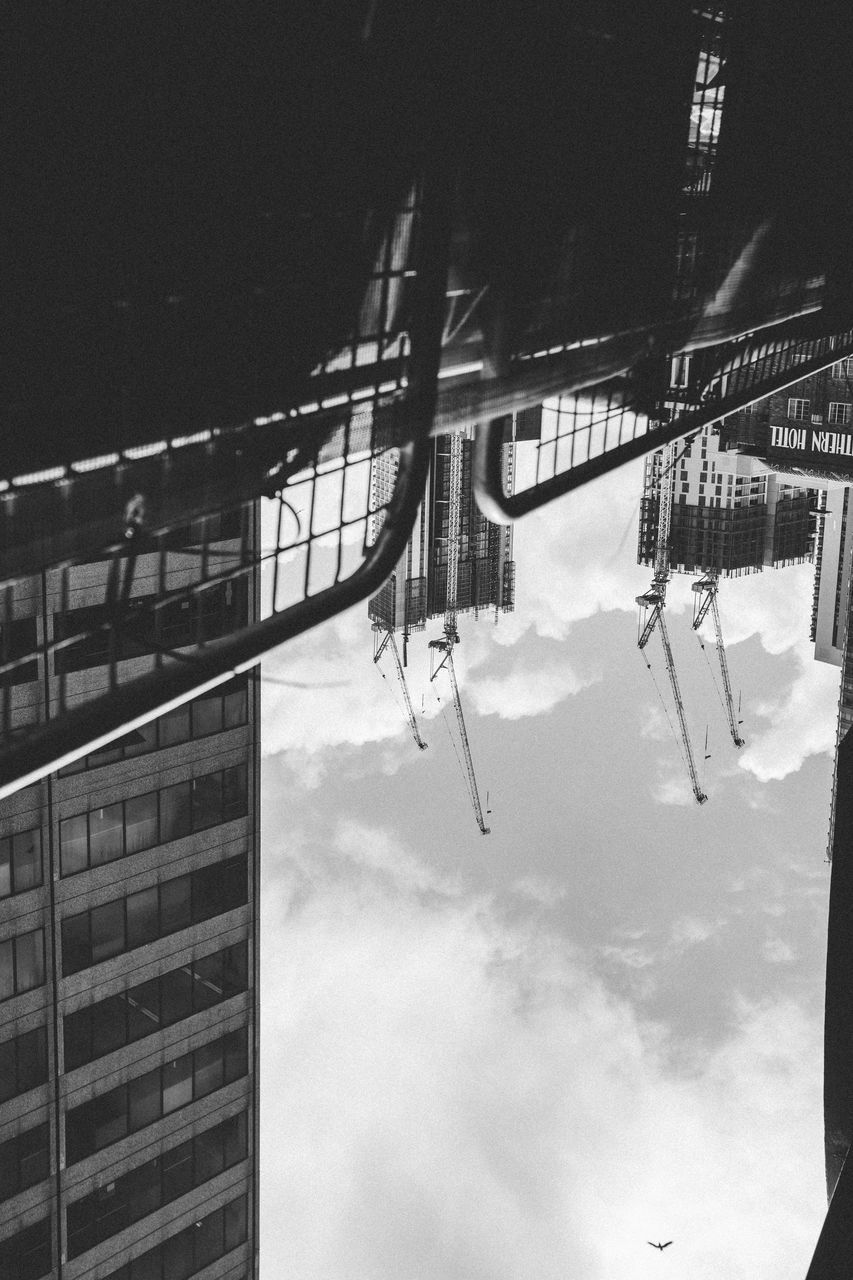 LOW ANGLE VIEW OF CLOTHES HANGING ON ROPE IN CITY