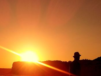 Silhouette of people at sunset