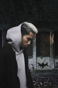 Side view of young man with dyed hair looking down