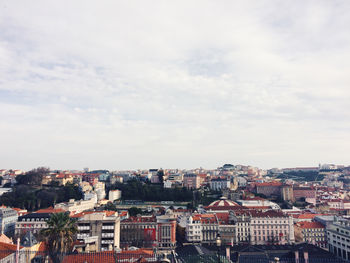 Scenic view of residential district against cloudy sky