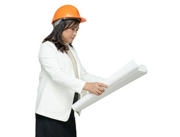 Woman wearing hat standing against white background