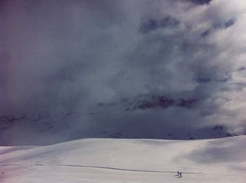 Scenic view of landscape against cloudy sky