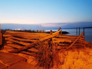 Scenic view of beach against clear sky during sunset