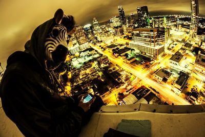 Woman standing in illuminated city at night