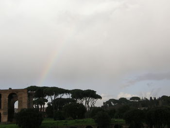 Scenic view of rainbow over building against sky