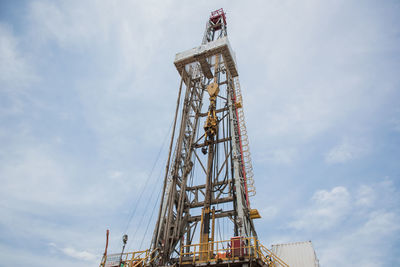 Low angle view of crane against sky