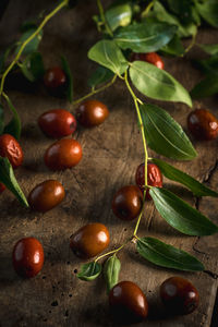 High angle view of fruits and leaves on table