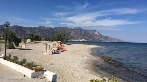 Scenic view of beach against blue sky