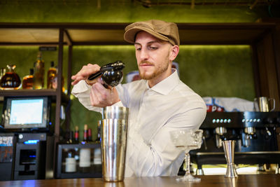 Bartender preparing drink at bar