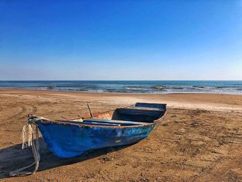 Scenic view of beach against clear blue sky