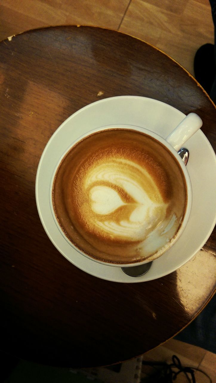 coffee cup, drink, indoors, refreshment, coffee - drink, food and drink, saucer, table, frothy drink, cappuccino, froth art, high angle view, coffee, freshness, still life, cup, directly above, spoon, close-up, latte