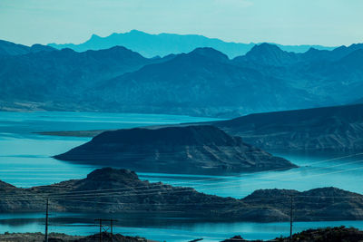 Blue river and rocky mountains against sky