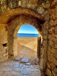 View of stone wall with sea in background