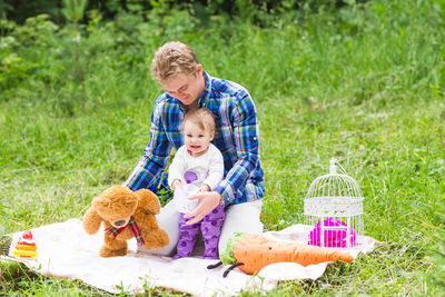 Full length of a boy with toy on grass