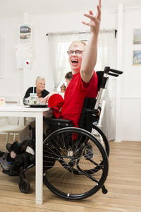 Smiling young man in wheelchair