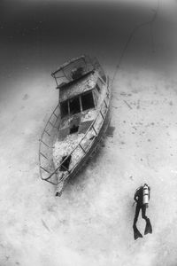 Scuba diver explores wreck in undersea