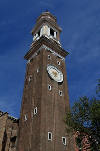 Low angle view of bell tower against sky