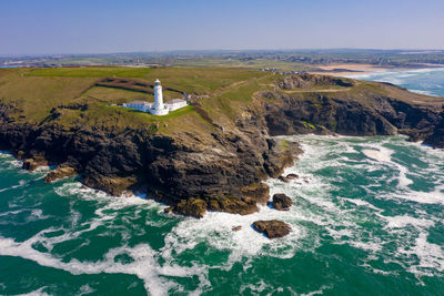 High angle view of rocks by sea against sky