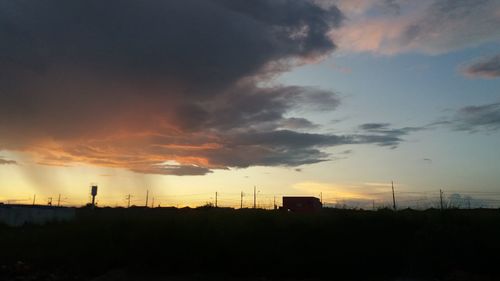 Silhouette buildings against sky during sunset