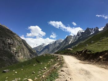 Road amidst mountains against sky