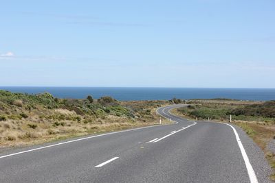 Road by sea against sky