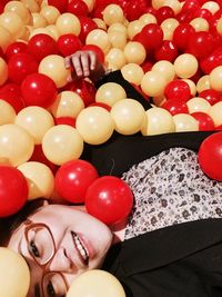 Close-up portrait of young woman at balloons