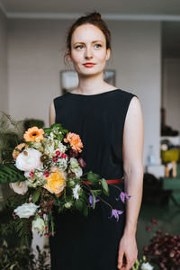 Woman holding flowers at home