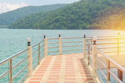 Staircase by sea against sky