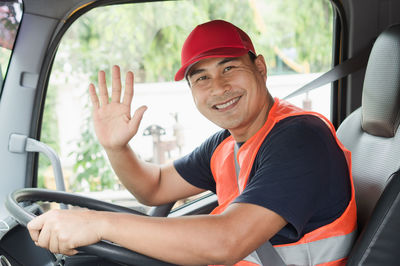 Portrait of smiling man sitting in car