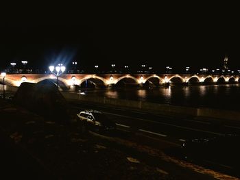 Illuminated bridge at night