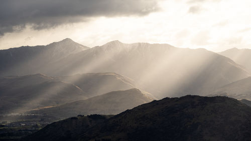 Beautiful landscape with multiple layers of mountains lit by warm and soft sunlight, new zealand