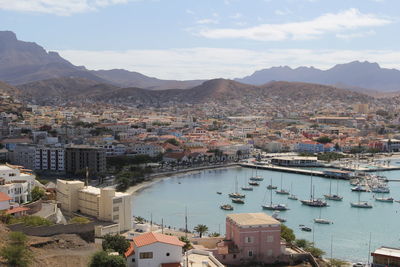 High angle view of townscape and mountains against sky