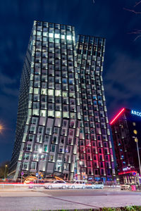 Low angle view of illuminated building against sky at night
